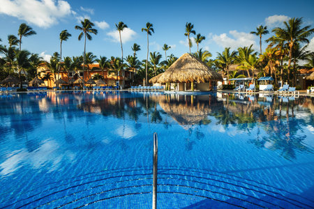 Tropical swimming pool and palm trees in luxury resortのeditorial素材