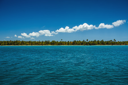 White fluffy clouds blue sky above a surface of the caribbean seaの写真素材