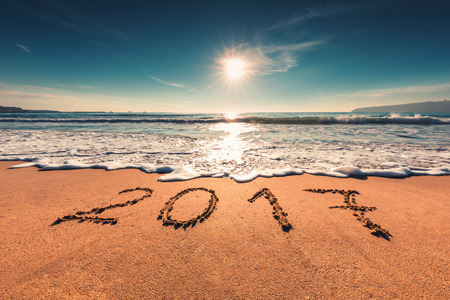 Happy New Year 2017 concept, lettering on the beach