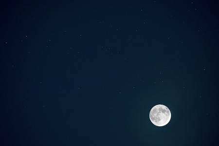 Full blue moon with star at dark night sky background