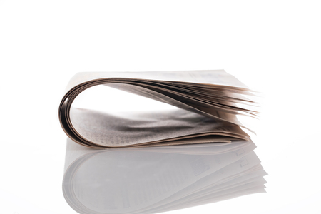 Old folded paper isolated on white backgroundの写真素材