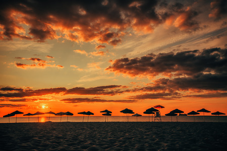 Silhouette of Beach Umbrellas, sunrise shot.の写真素材