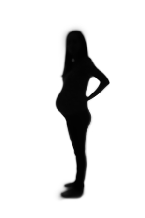 Defocused silhouette of pregnant woman isolated on white background.の写真素材