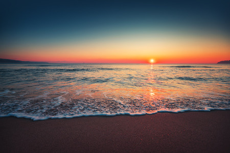 Sea wave close up, low angle view, sunrsie shot.の写真素材