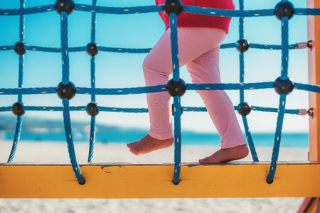 Little girl, climbing on the playgroundの写真素材