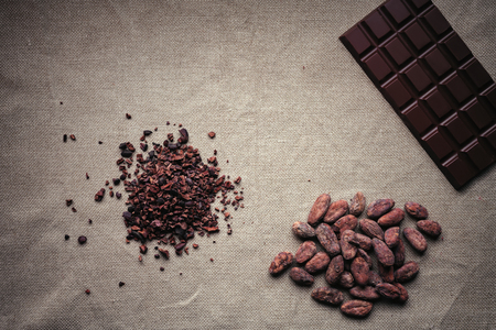 Heap of cacao nibs, cocao beans and dark chocolateの写真素材