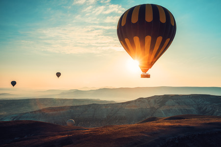 Hot air balloons flying over the valley at Cappadocia, Turkey.の写真素材