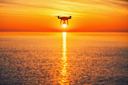 Beautiful morning over the sea and flying drone.の写真素材