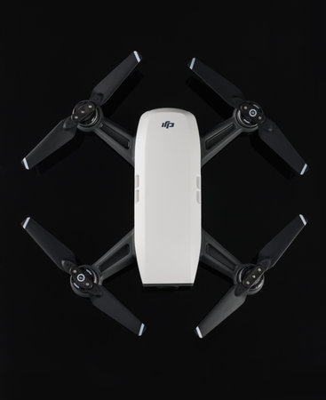 Varna, Bulgaria - February 14 ,2018: Flying drone quadcopter Dji Spark is mini drone that features all of DJI's signature technologies, isolated on blackのeditorial素材