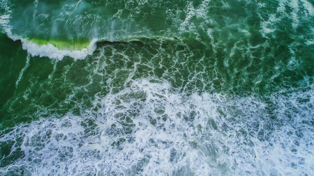 Aerial view of green sea waves.