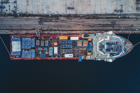 Container ship in export and import business and logistics. Shipping cargo to harbor by crane....