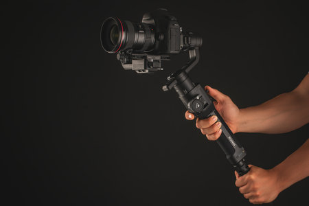 Varna, Bulgaria - July 11 ,2018: DJI Ronin-S is Three-Axis Motorized Gimbal Stabilizer for DSLR or Mirrorless Cameras manufactured by DJI company ,isolated on black.のeditorial素材
