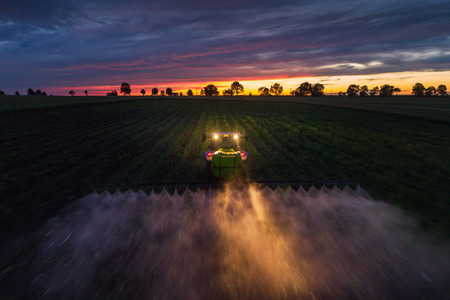 Tractor spraying field at spring,aerial viewの写真素材