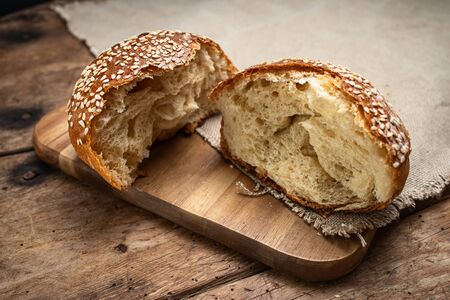Homemade sourdough bread round bun on wooden background.の写真素材