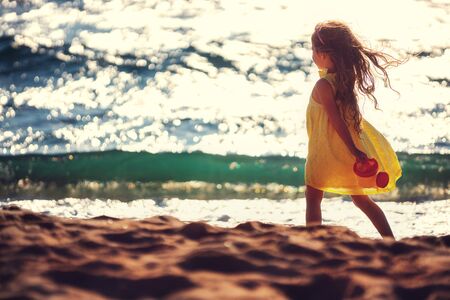 Little girl playing on the beach.の写真素材