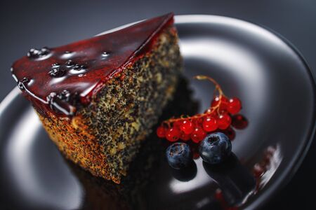 Cake with berry fruits, chia cereals and nuts isolated on black background.の写真素材