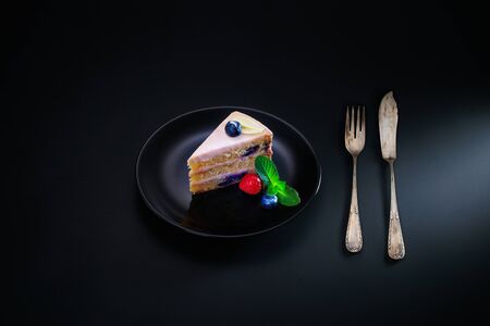 Cake chocolate with yogurt cream and blueberries fruits isolated on black background