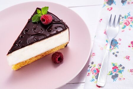 Chocolate cake with decoration and fruits as background.