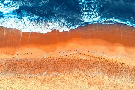 Aerial view of waves in a beach.