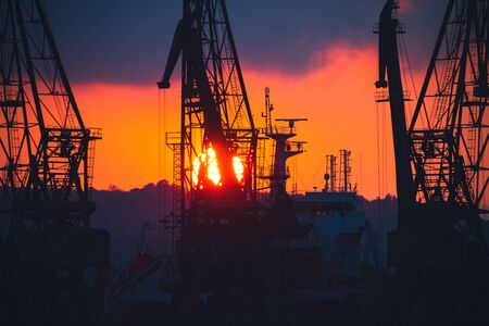 Colorful sunset over sea port and industrial cranes, Varna, Bulgaria