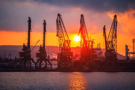 Colorful sunset over sea port and industrial cranes, Varna, Bulgaria