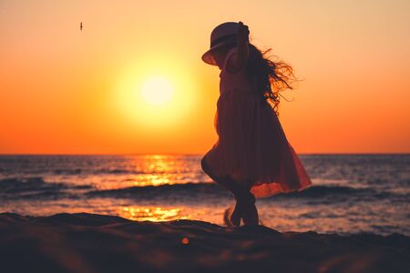 Little girl playing on the beach.の写真素材