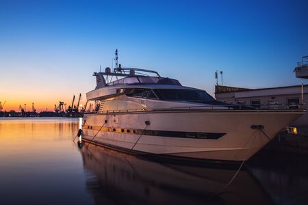 Yacht port and beautiful sunset over Varna, Bulgaria. Sailboat harbor, many beautiful moored sail yachts in the sea.の写真素材