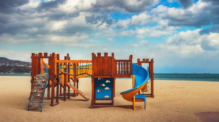 Wooden playground for small children on the beach in sunny morning.の写真素材