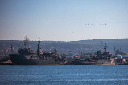 Military ships moor in sea harbour