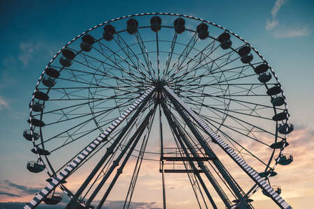 Ferris Wheel with sunset sky and cloudsの写真素材