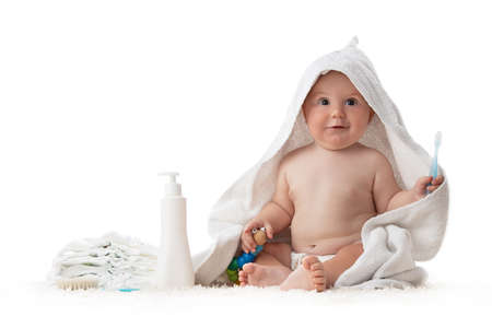 Adorable happy baby smiling under a white towelの写真素材