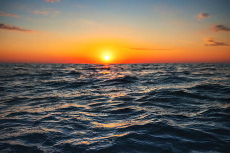 Sea wave close up, low angle view, sunrsie shot.の写真素材