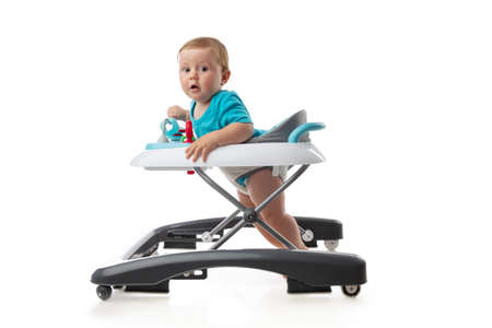Baby and baby walker with  toys isolated on whiteの写真素材