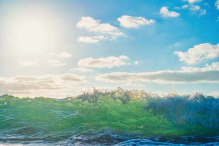 Sea wave close up, low angle view, sunrsie shot.の写真素材