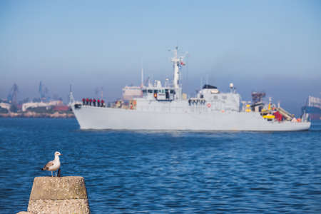 Patrol boat and sea port Varna, Bulgaria. Industrial cranes, ships and boats on the harbour.の写真素材