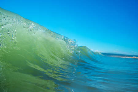 Sea wave close up, low angle view, sunrsie shot.の写真素材