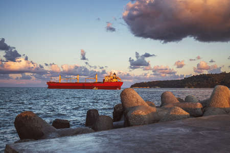 Cargo ship with containers on the harbour. Sea port Varna, Bulgaria.