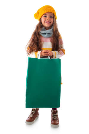 Happy beautiful young girl with shopping bag, portrait on white backgroundの写真素材
