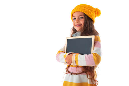 Happy smiling beautiful young girl showing blank signboard or copyspace for slogan or text, isolated over white backgroundの写真素材