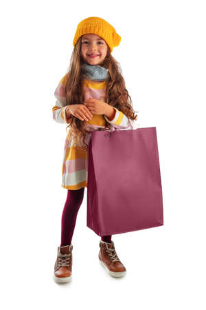 Happy beautiful young girl with shopping bag, portrait on white backgroundの写真素材