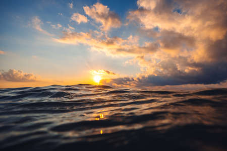 Sea wave close up, low angle view, sunrsie shot.の写真素材
