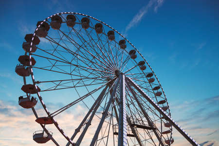 Ferris Wheel with sunset sky and cloudsの写真素材