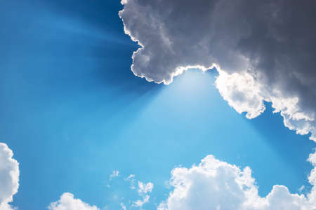 Sun, sunbeam and clouds in blue skyの写真素材