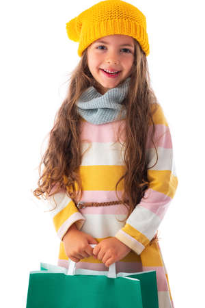 Happy little girl with autumn clothes and shopping bag portrait, copy space for text.の写真素材
