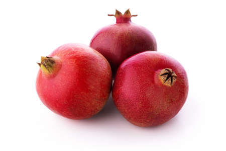 Ripe pomegranate fruits isolated on white backgroundの写真素材