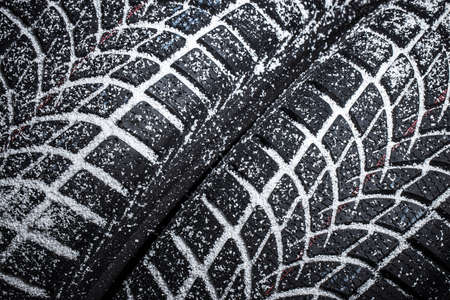 Winter Car tire with snow on black backgroundの写真素材