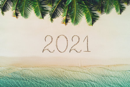 Happy new year beach concept, 2021 written on the sand. Summer holiday on tropical island. Palm trees and sea waves.の写真素材