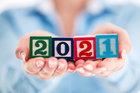 2021 Business concept. Woman holding wooden cubes.の写真素材