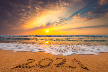 Happy New Year 2021 concept, lettering on the beach. Written text on the sea beach at sunrise.の写真素材