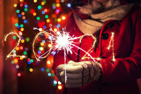 Woman holding bengal lights over bokeh background. Christmas concept.の写真素材